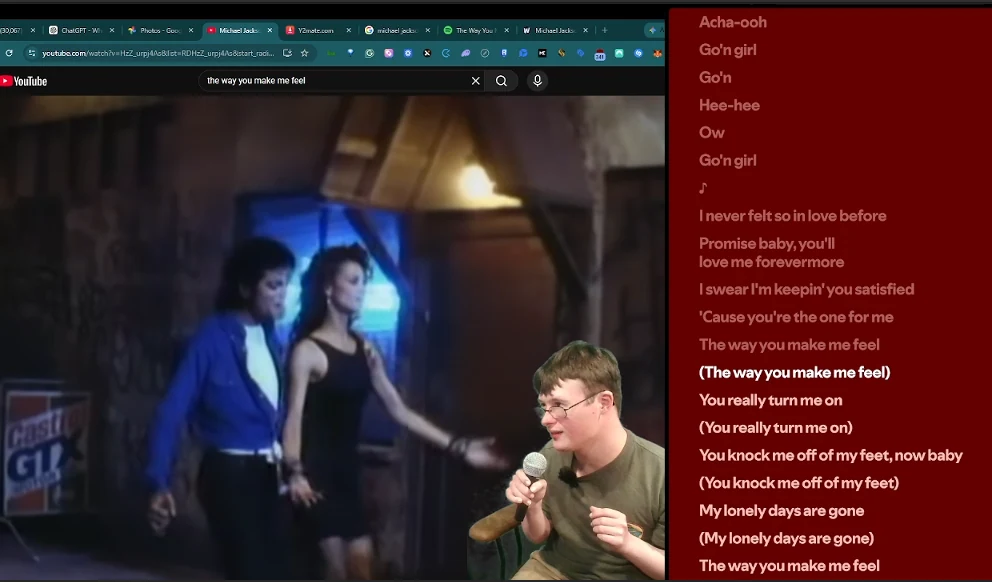 Brendan singing into a microphone while following lyrics on a screen